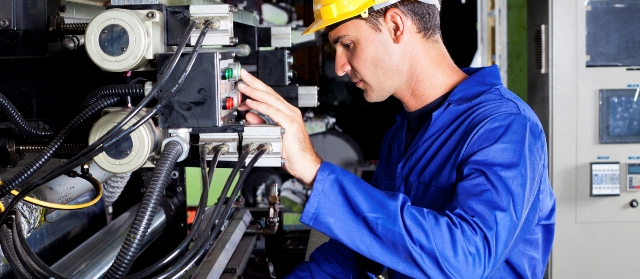 male caucasian operator operating industrial printing press